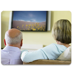 Man and women watching flat-panel TV